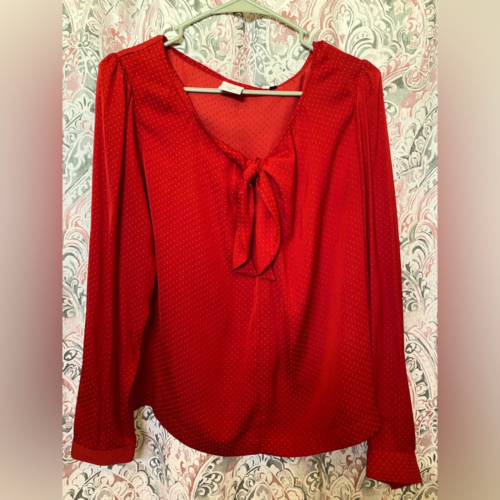 Red long sleeve shirt with bow in front and light red polka dots. Size Large
